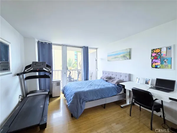 a bedroom with a bed and a desk