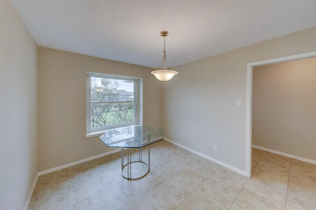a view of a room with window and chandelier fan