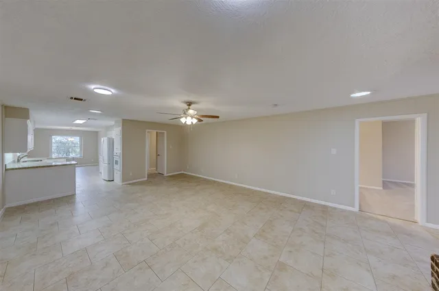 an empty room with a kitchen and a sink