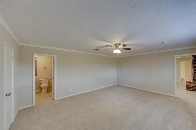 an empty room with closet and a chandelier fan
