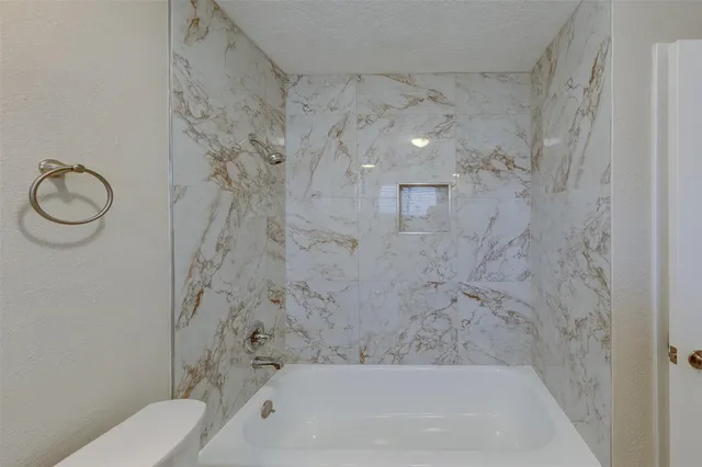 a bathroom with a bathtub and a shower