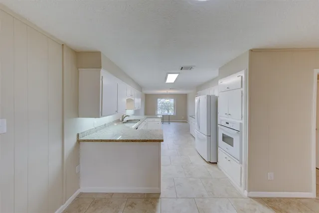a bathroom with a granite countertop sink a toilet and shower