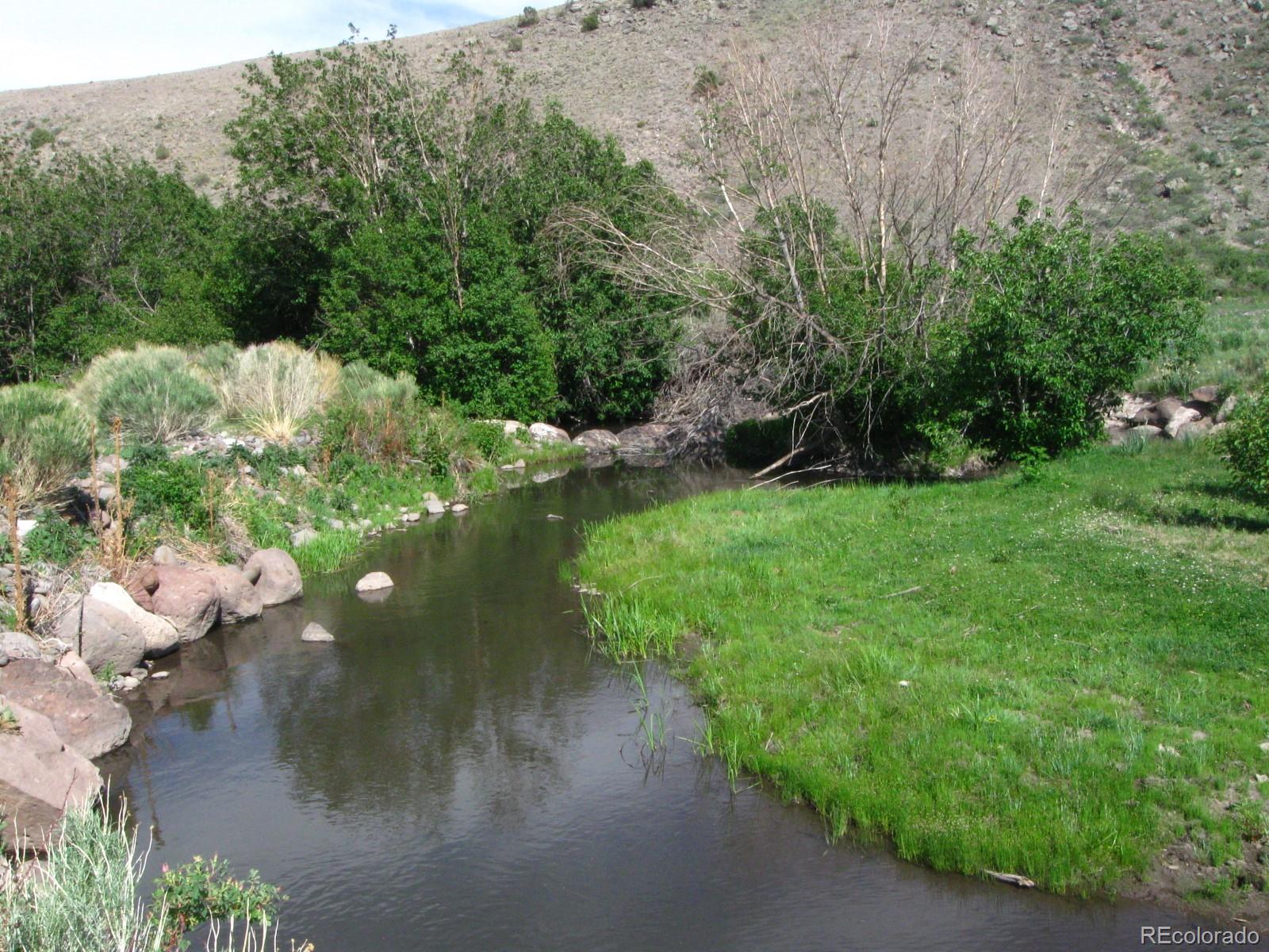 Lot 23 Canyon Road Antonito, CO 81120 - Photo 3 of 29 a backyard of a house with a yard and outdoor seating