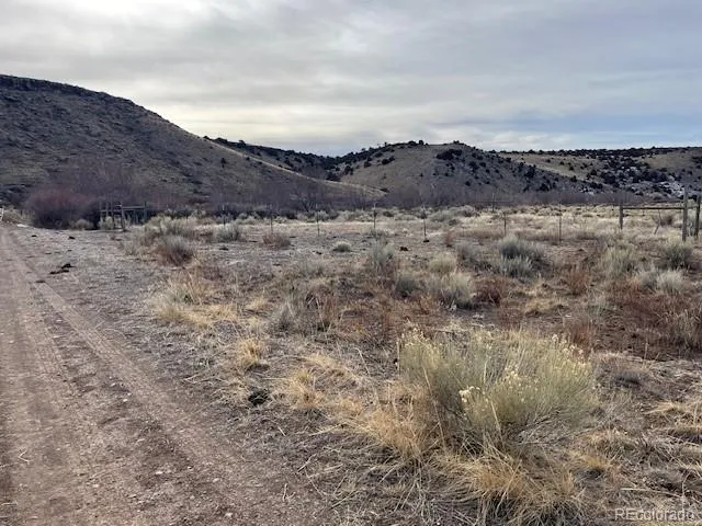 a view of a dry yard with a barn