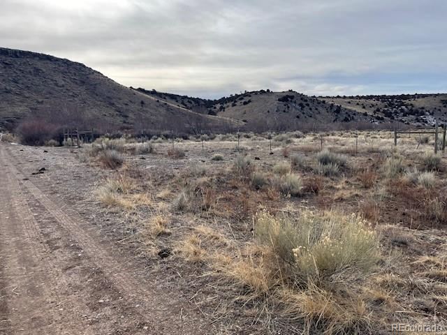 Lot 23 Canyon Road Antonito, CO 81120 - Photo 9 of 29 a view of a dry field with mountains in the background