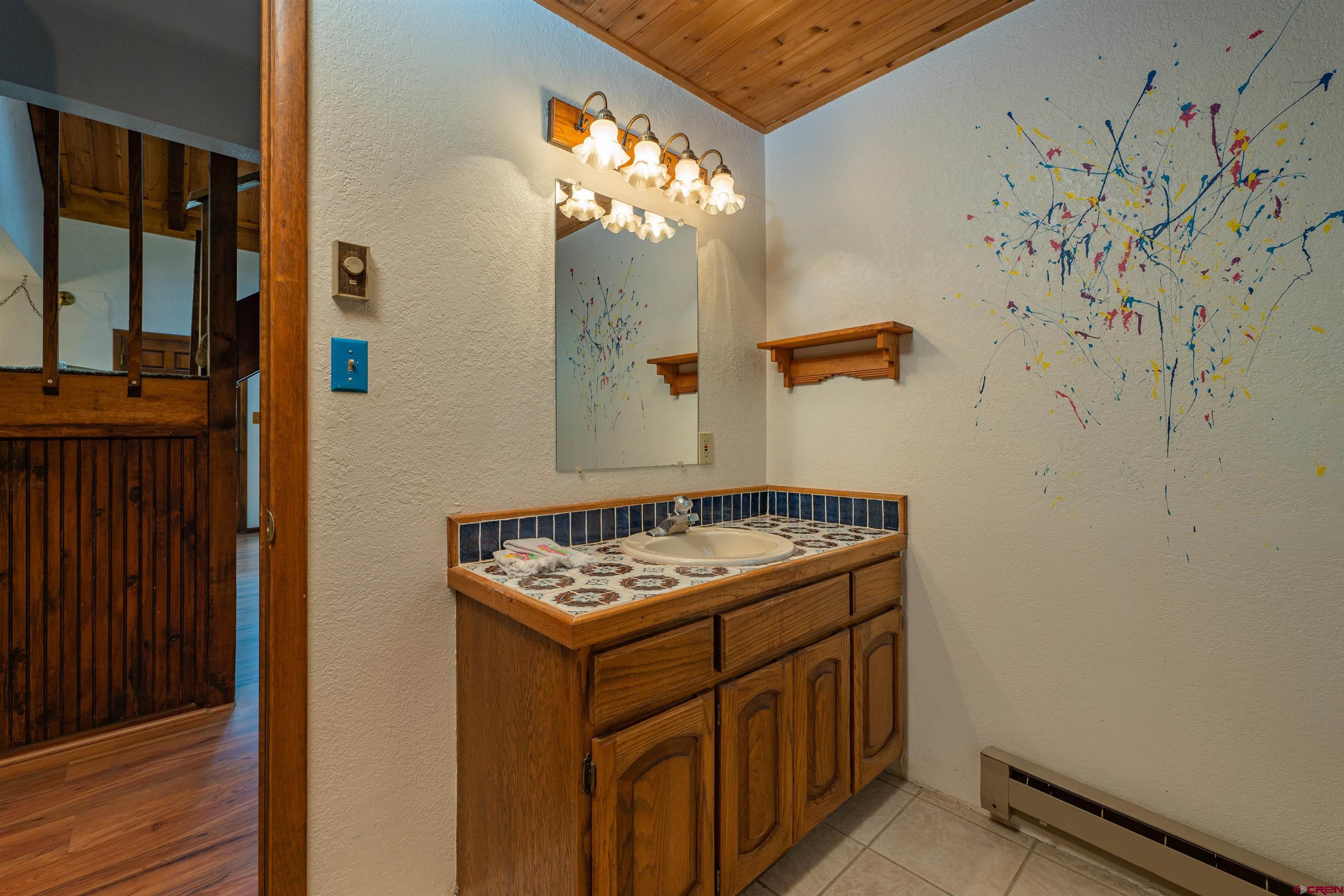 284 Willow Drive Durango, CO 81301 - Photo 12 of 35 a bathroom with a sink a mirror and a shower