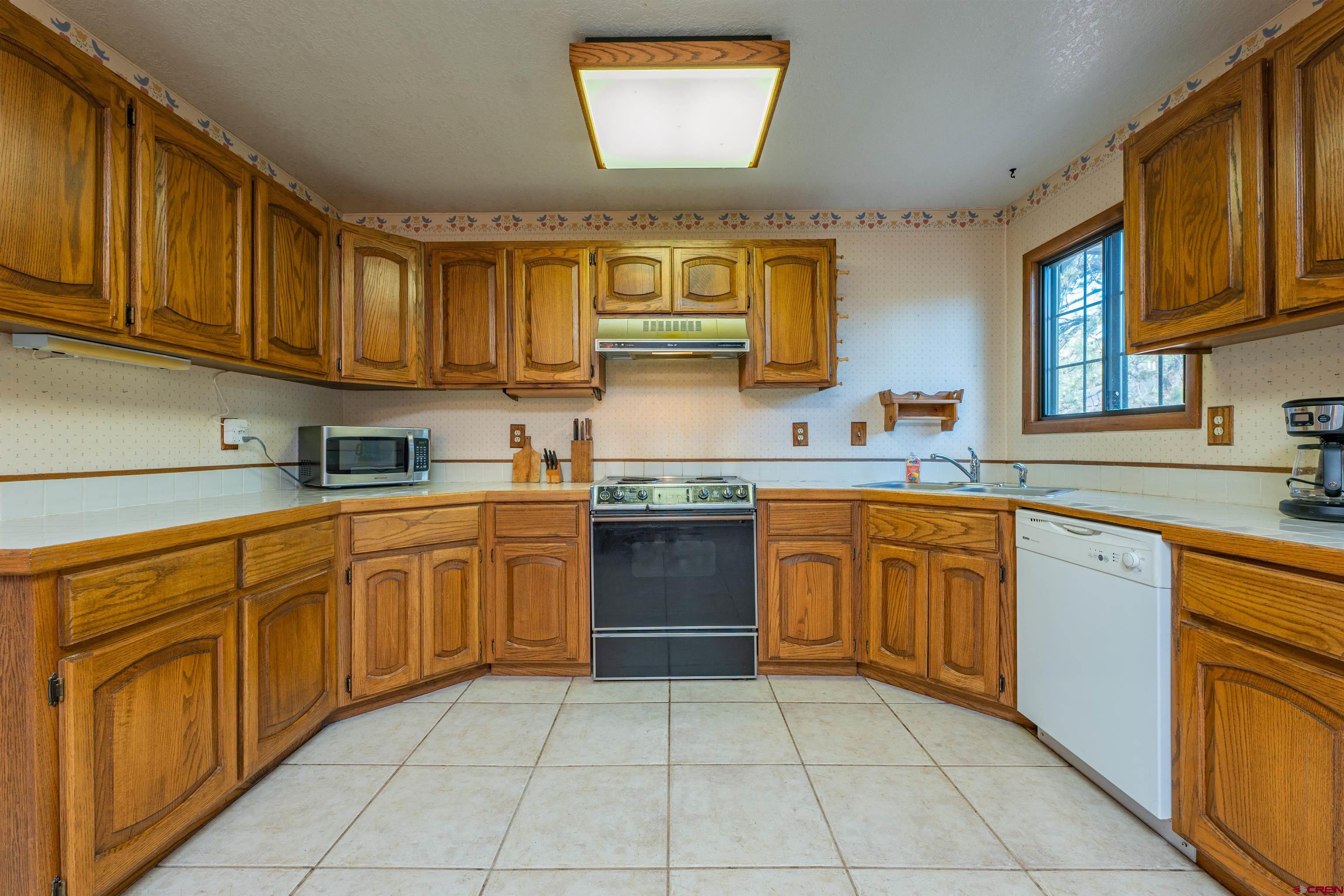 284 Willow Drive Durango, CO 81301 - Photo 7 of 35 a kitchen with stainless steel appliances granite countertop a sink and cabinets
