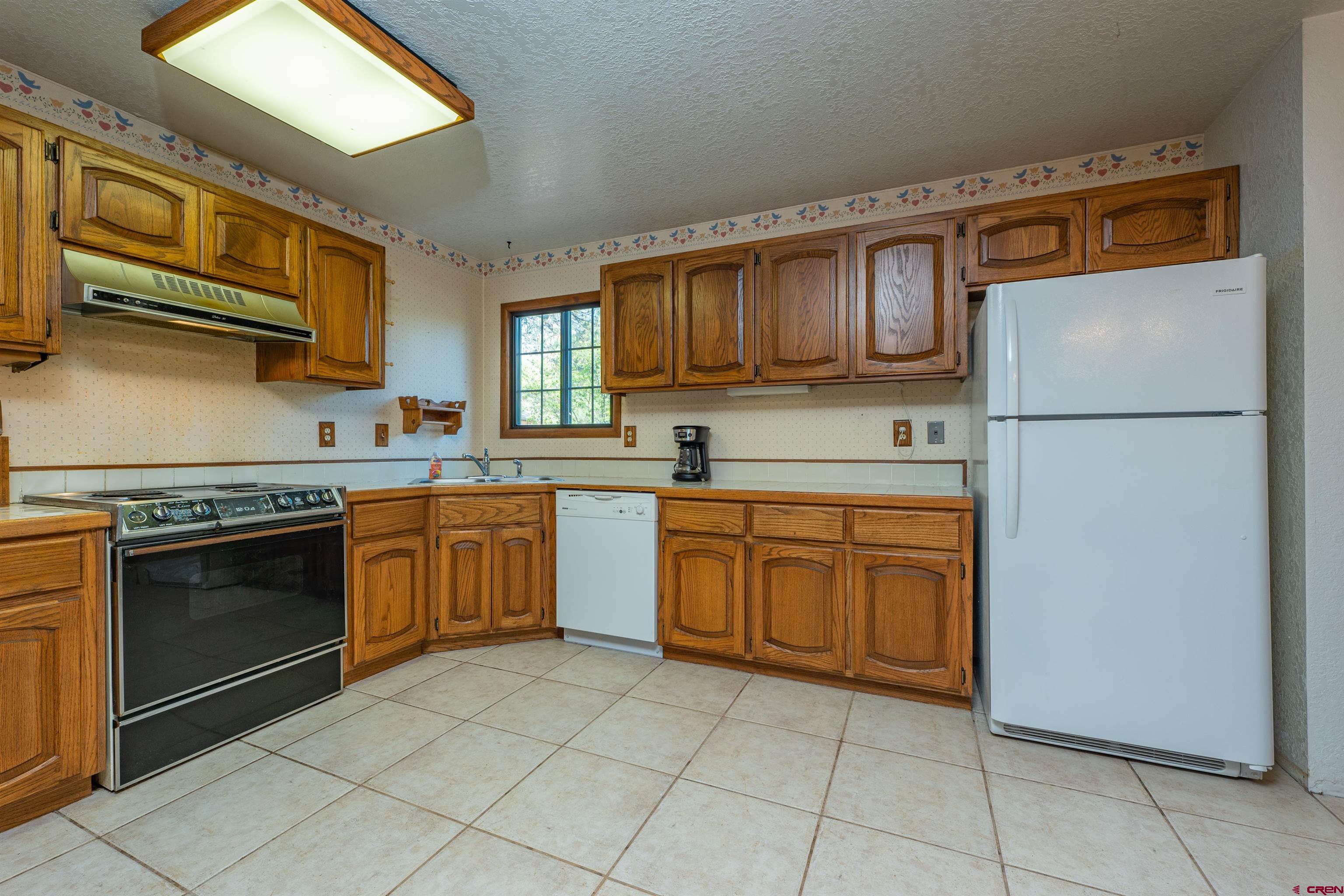 284 Willow Drive Durango, CO 81301 - Photo 9 of 35 a kitchen with a sink a stove top oven and cabinets