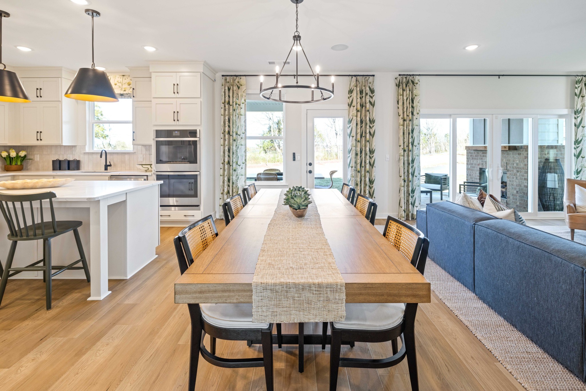 6019 Bloom Street Rockvale, TN 37153 - Photo 13 of 45 a dining room with wooden floor a chandelier a wooden table and chairs