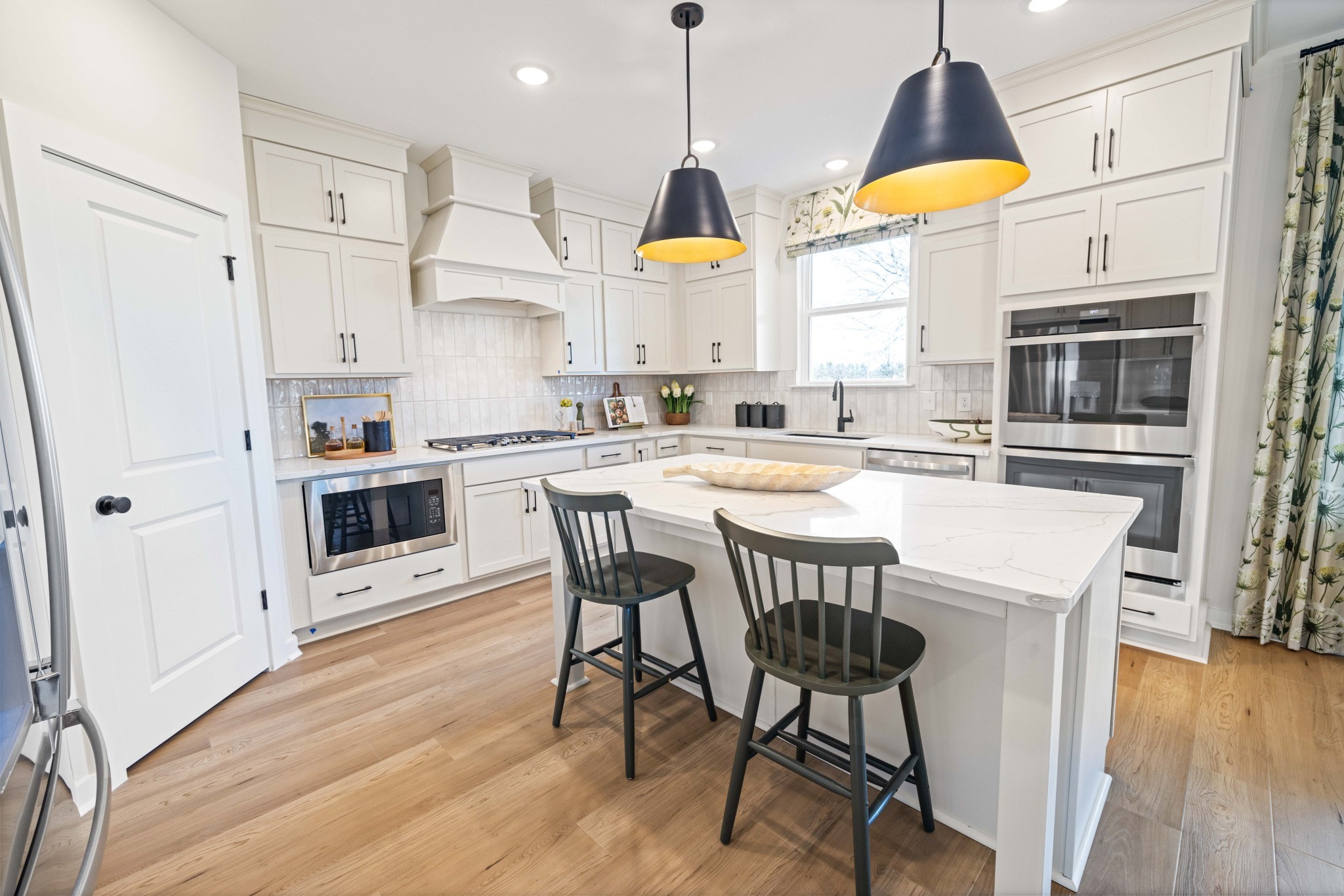 6019 Bloom Street Rockvale, TN 37153 - Photo 15 of 45 a kitchen with stainless steel appliances granite countertop a stove a refrigerator a microwave a dining table and chairs with wooden floor