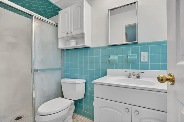 a bathroom with a sink toilet and mirror