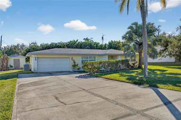 a view of house with outdoor space and swimming pool