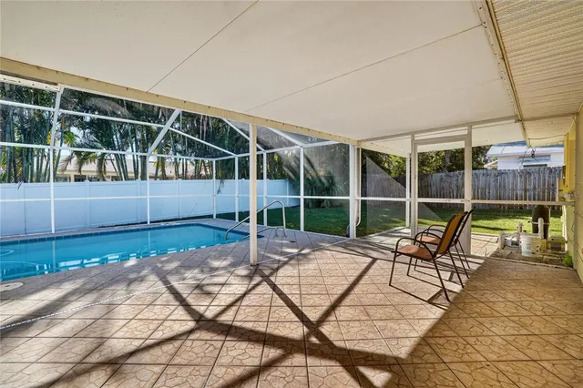 a view of a house with backyard and sitting area