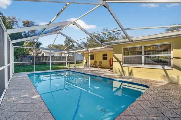 a view of a backyard with a swimming pool
