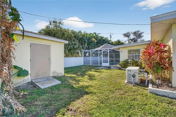 a view of a house with a small yard and wooden fence