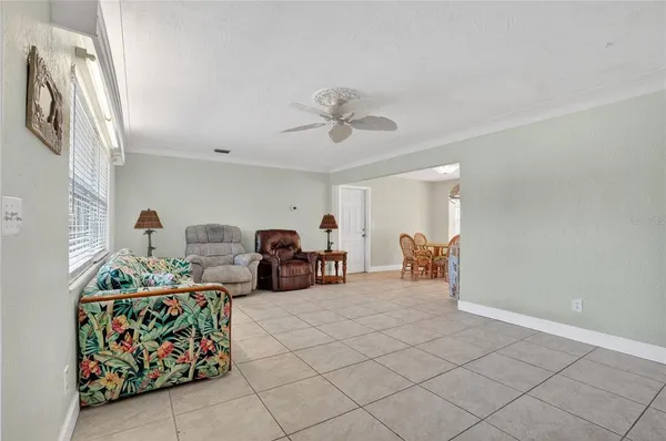 a bedroom with furniture and a fan