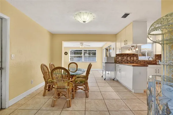 a view of a dining room with furniture and chandelier