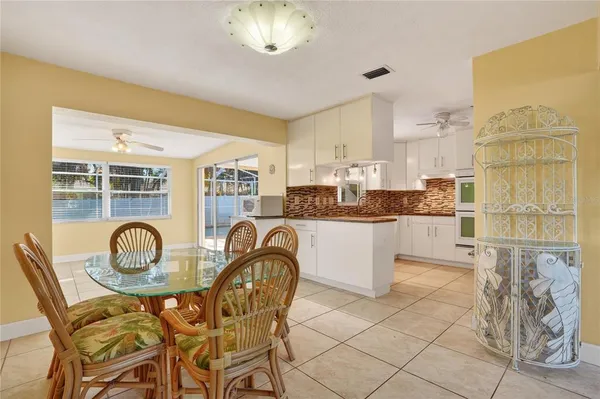 a kitchen with granite countertop a table and chairs