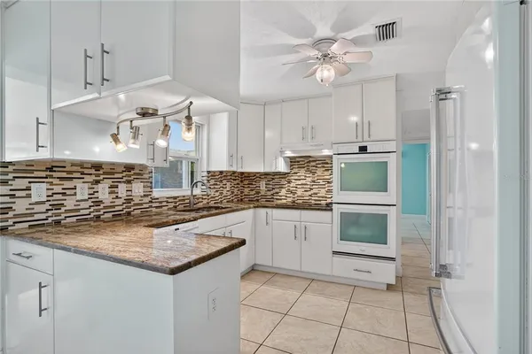 a kitchen with a stove a sink and a refrigerator