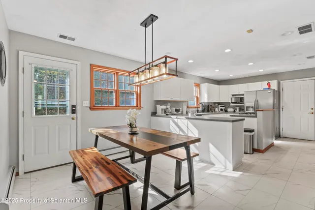 a kitchen that has a sink and a stove in it
