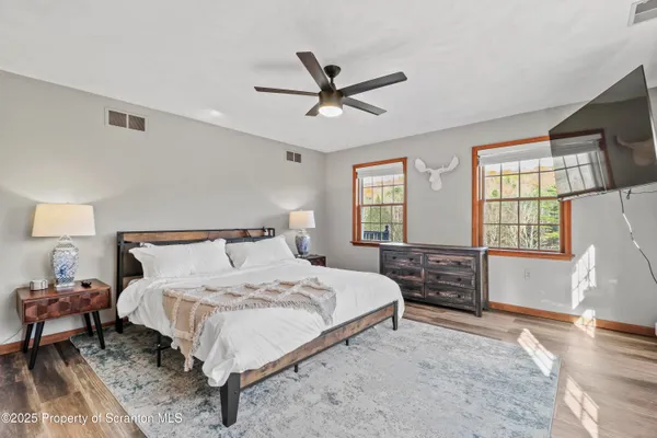 a bedroom with a bed a lamp and a dresser
