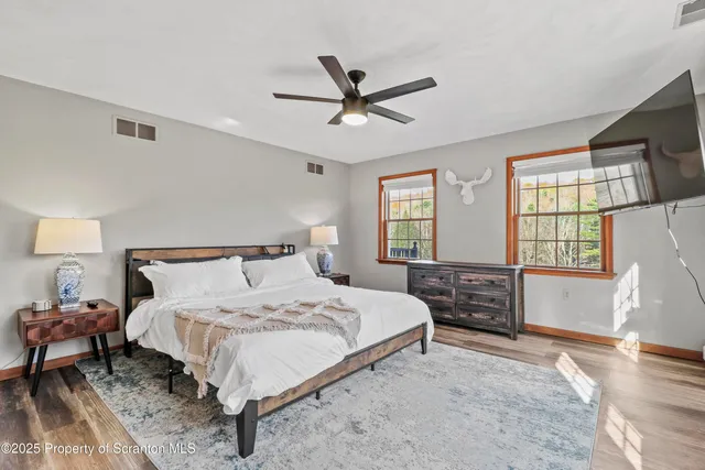 a bedroom with a bed a lamp and a dresser