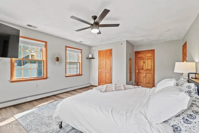 a kitchen with stainless steel appliances granite countertop a stove and a wooden floor