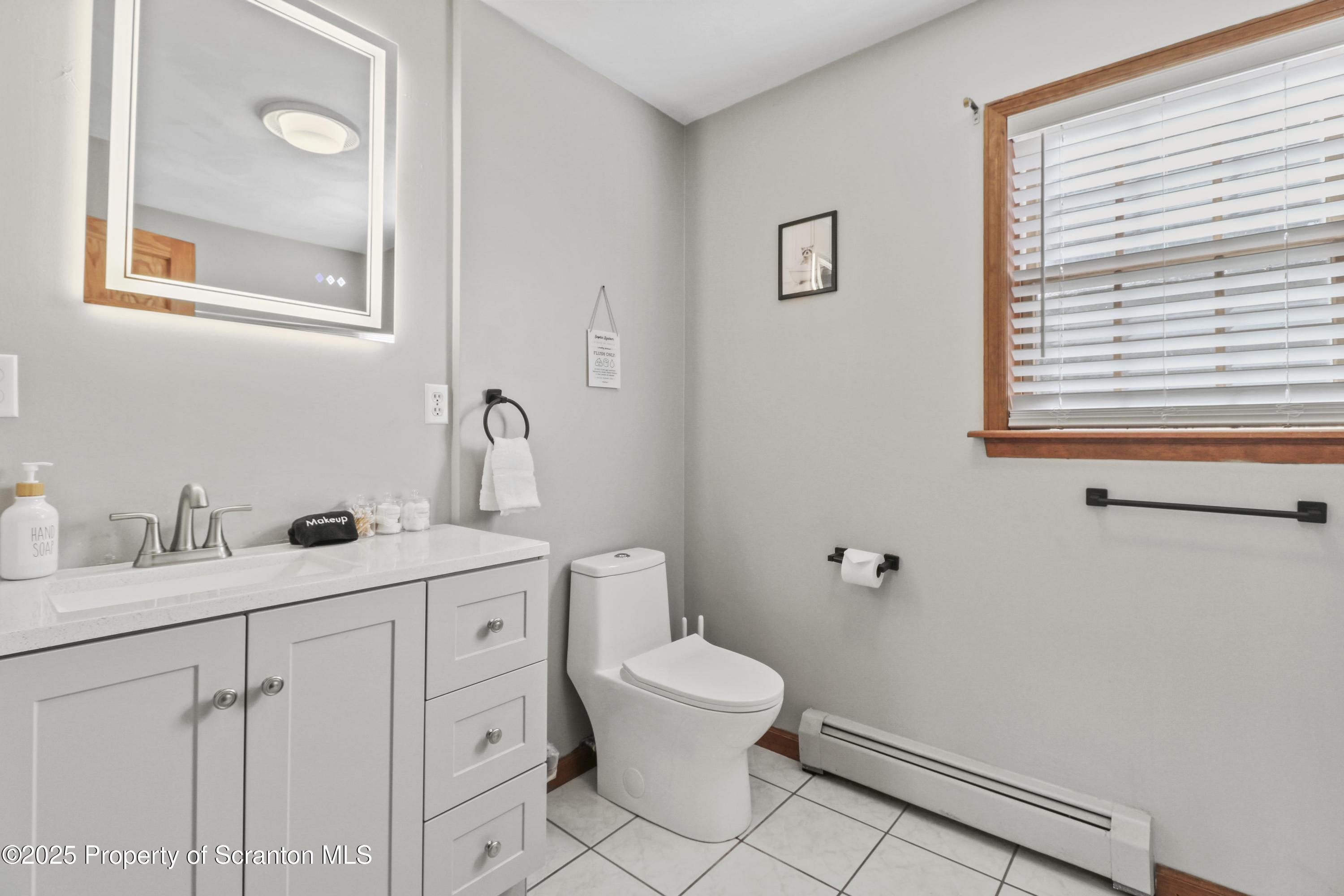1509 Creek Road New Milford, PA 18834 - Photo 18 of 64 a bathroom with a toilet a sink and mirror