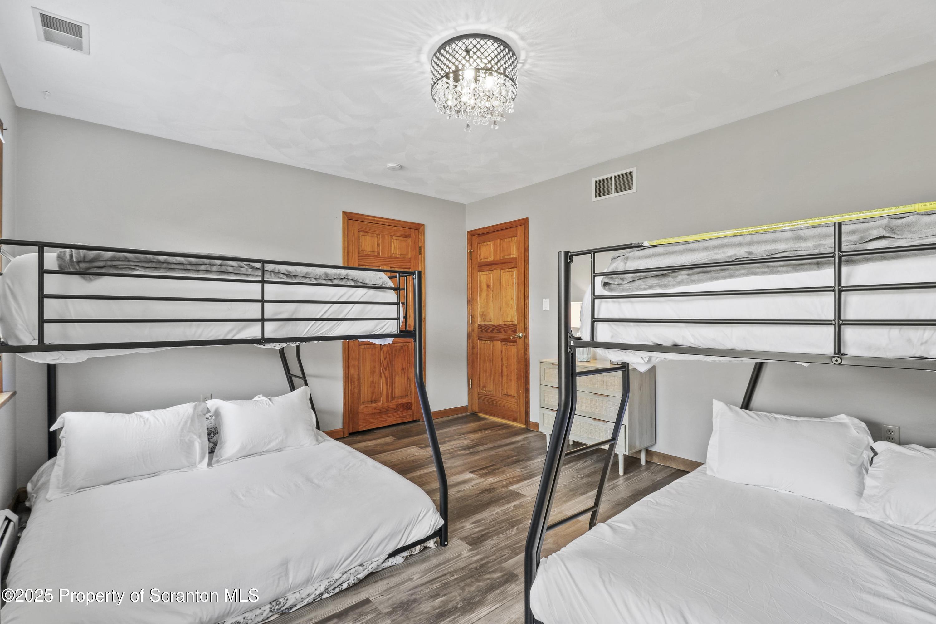 1509 Creek Road New Milford, PA 18834 - Photo 22 of 64 a bedroom with a bed a lamp and a dresser