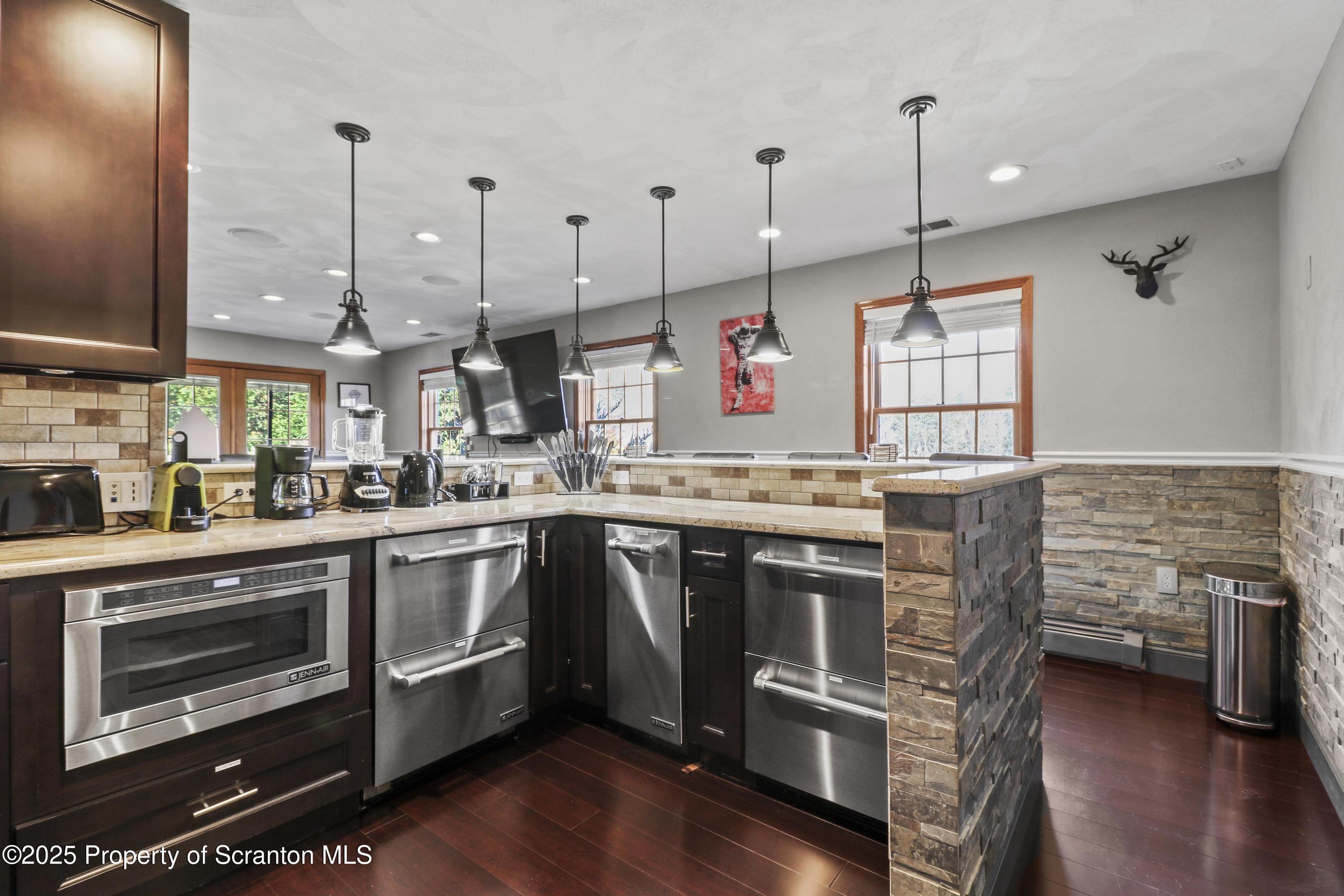 1509 Creek Road New Milford, PA 18834 - Photo 23 of 64 a kitchen with stainless steel appliances granite countertop a stove and a wooden floor