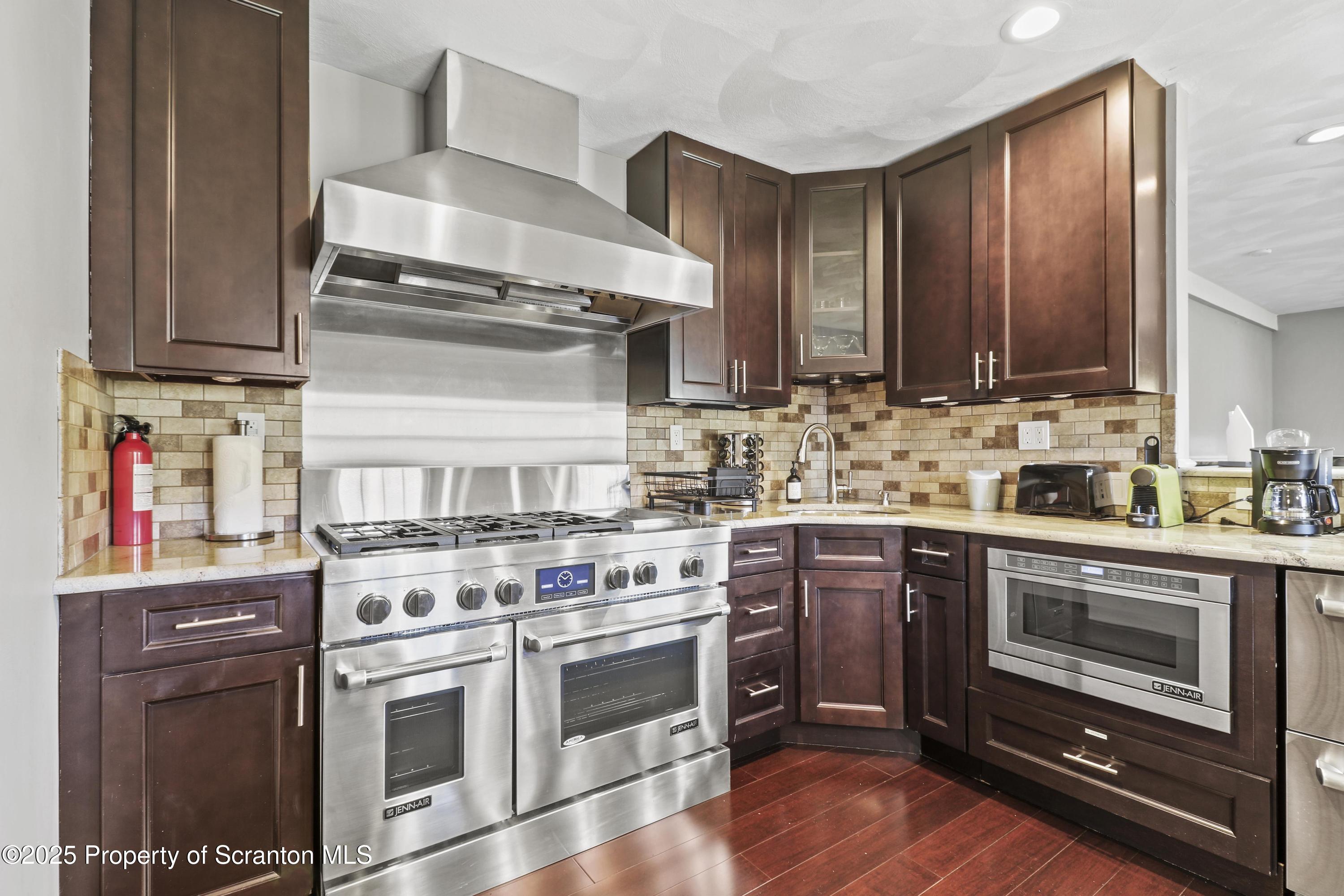 1509 Creek Road New Milford, PA 18834 - Photo 24 of 64 a kitchen with stainless steel appliances granite countertop a stove and a sink
