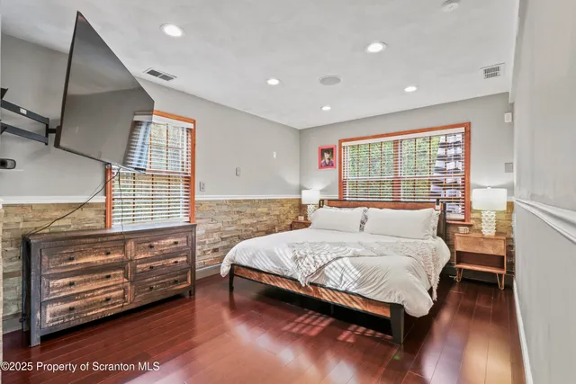 a room with lots of furniture and a wooden floor