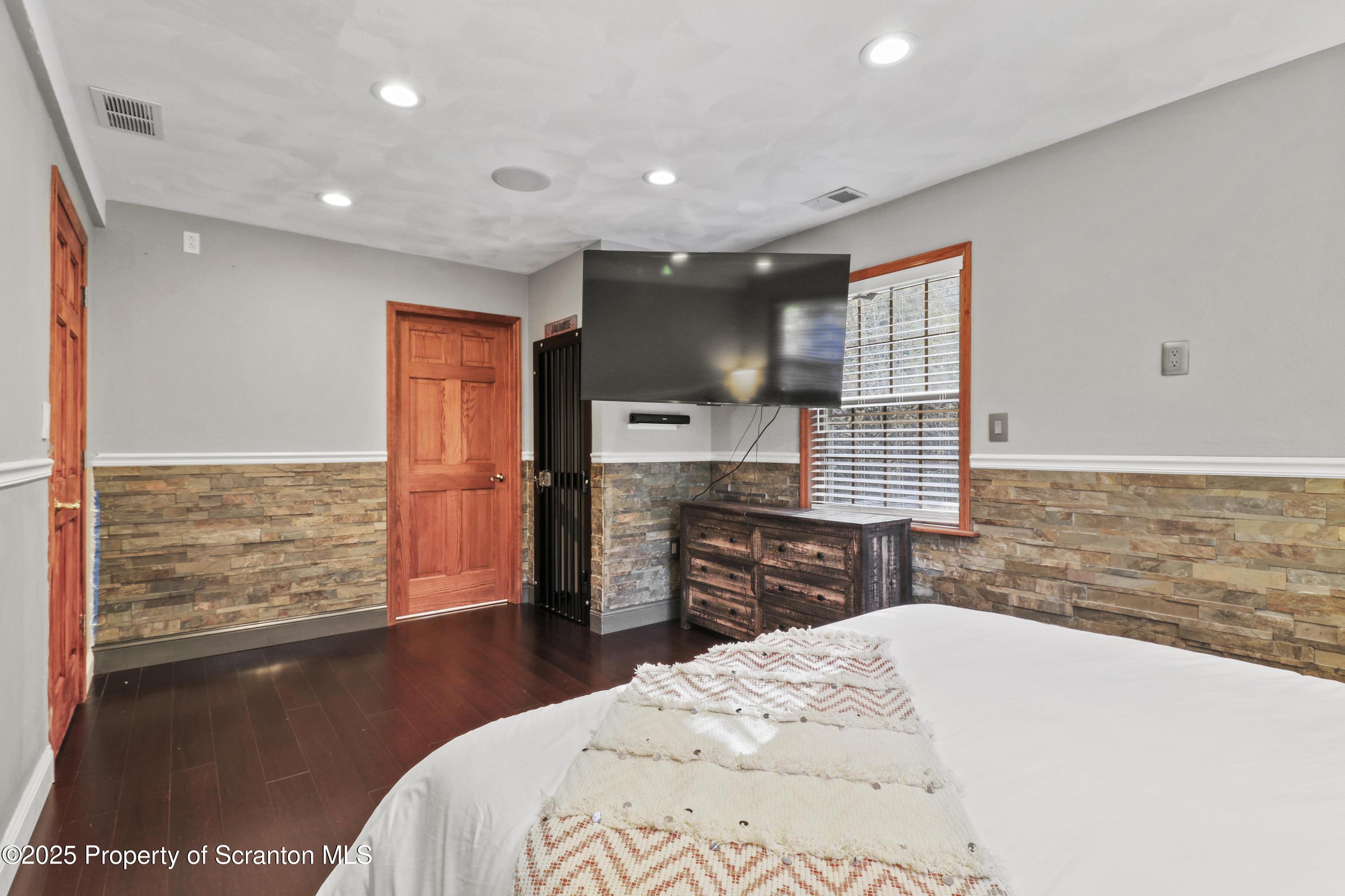 1509 Creek Road New Milford, PA 18834 - Photo 28 of 64 a spacious bedroom with a bed and wooden floor