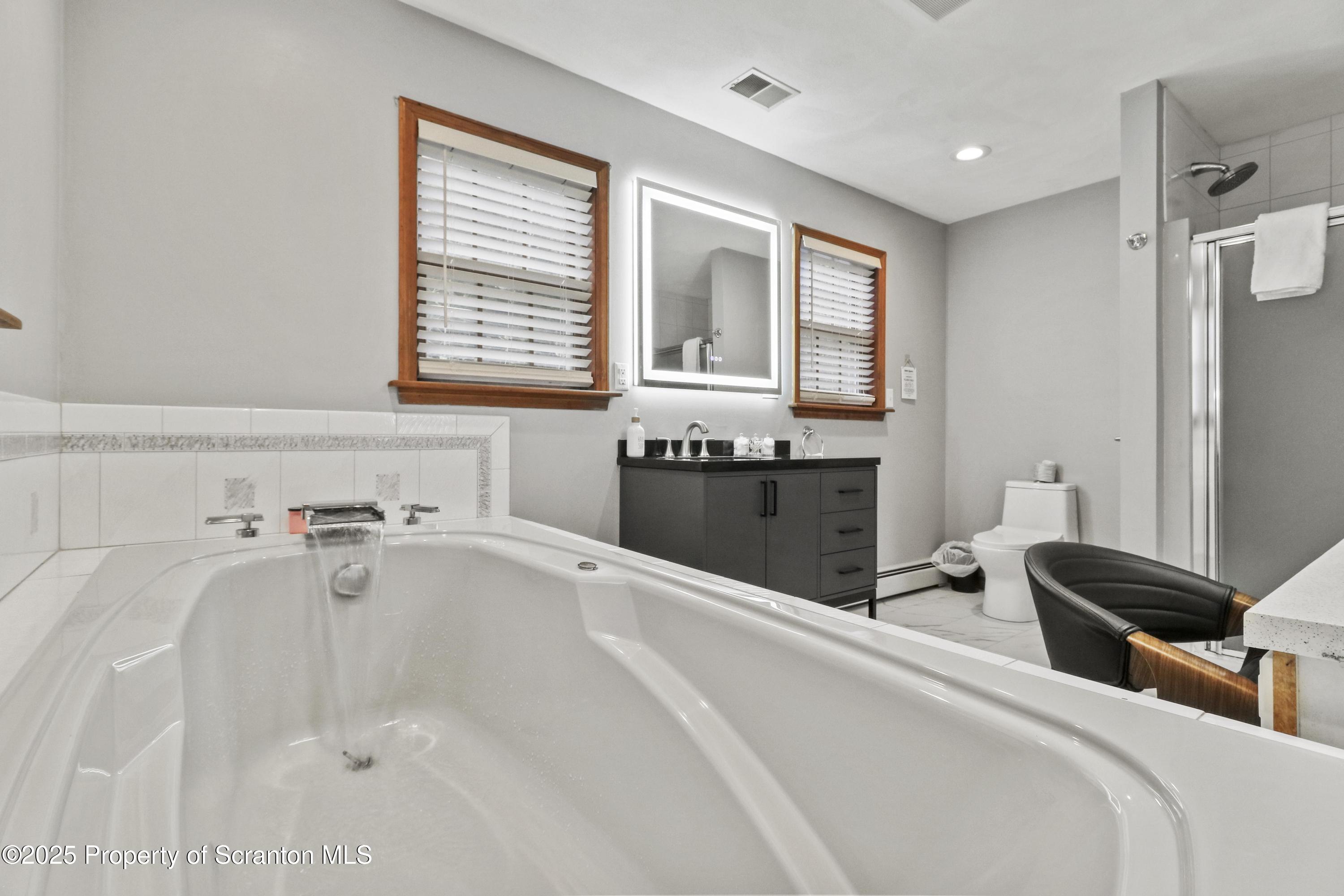1509 Creek Road New Milford, PA 18834 - Photo 33 of 64 a spacious bathroom with a bathtub and a window