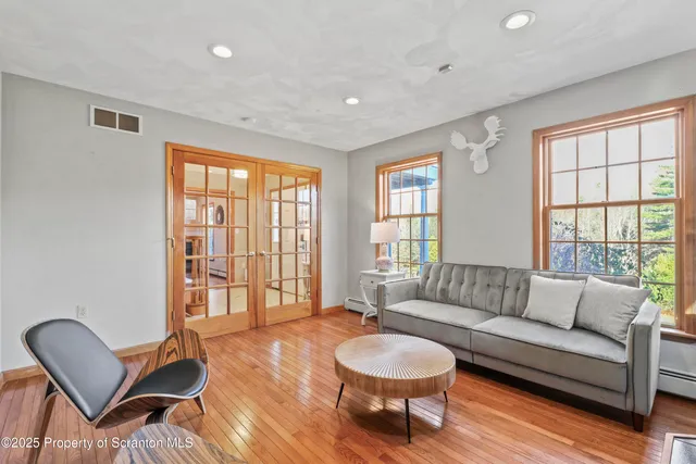a living room with furniture and flat screen tv