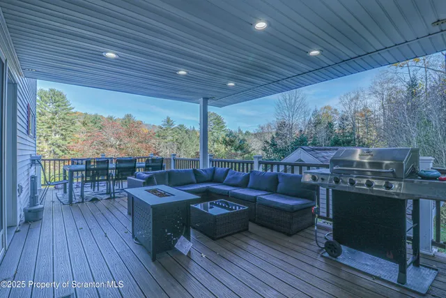 a aerial view of a house with swimming pool and large trees