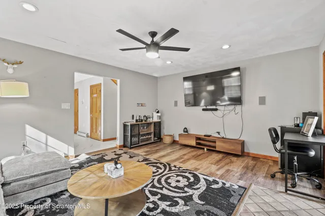 a view of a dining room with furniture a chandelier and wooden floor