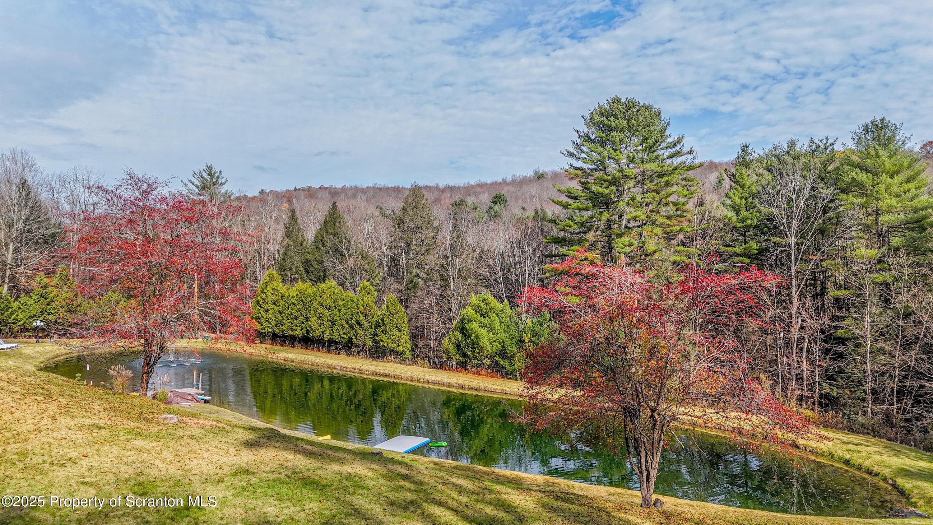1509 Creek Road New Milford, PA 18834 - Photo 58 of 64 a view of a lake with a house in the background