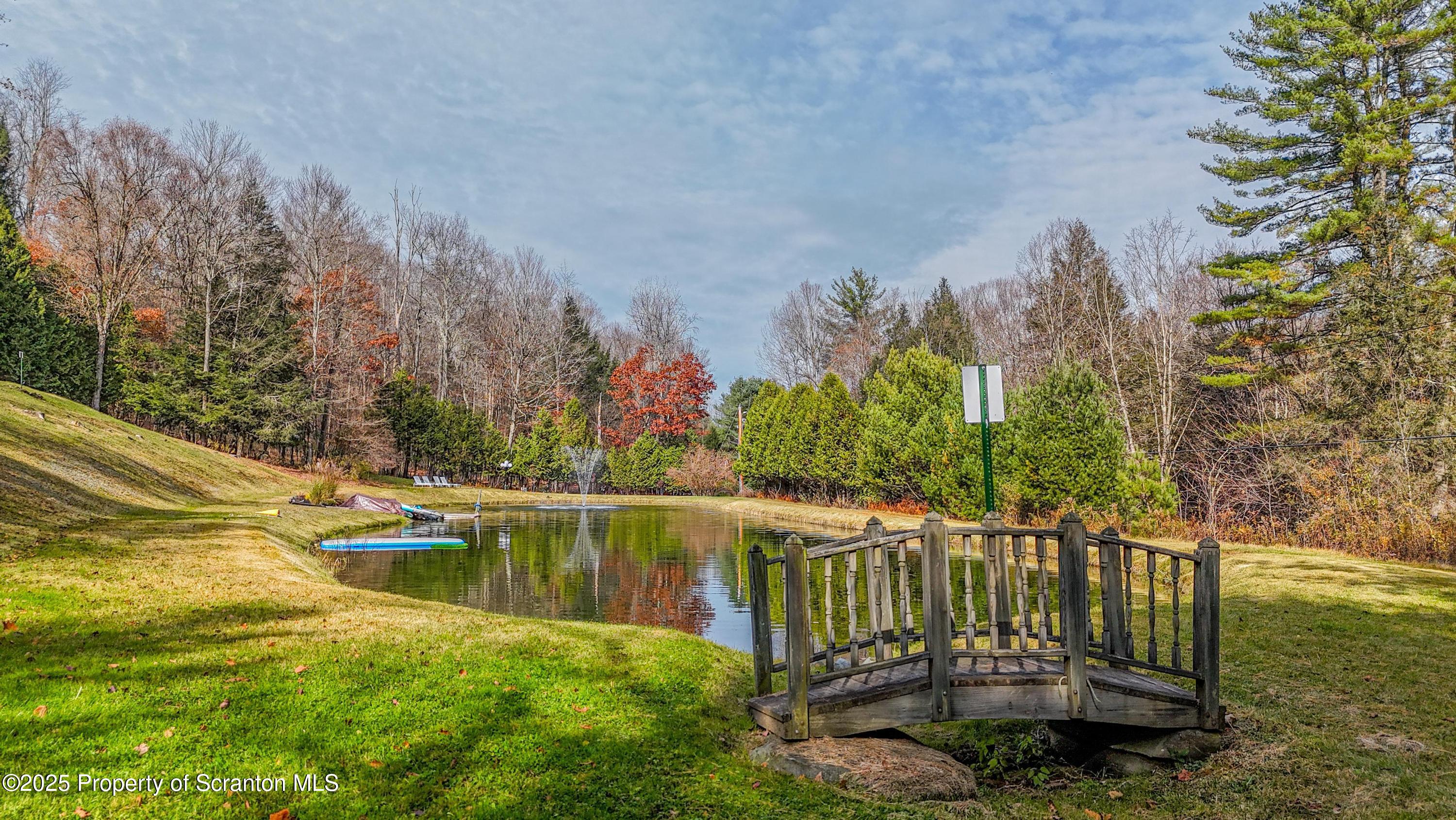 1509 Creek Road New Milford, PA 18834 - Photo 59 of 64 a view of a lake with a house in the background