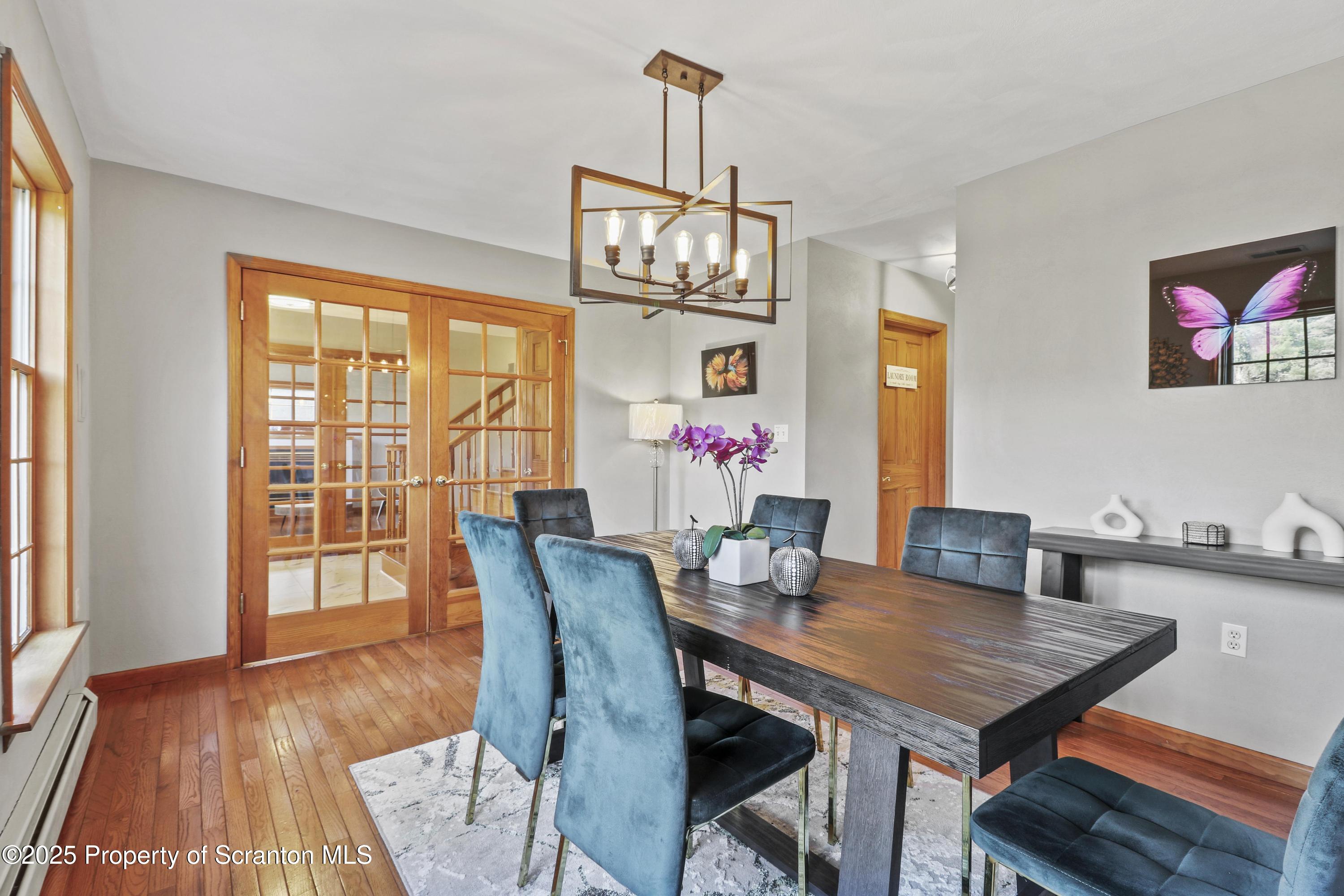 1509 Creek Road New Milford, PA 18834 - Photo 8 of 64 a view of a dining room with furniture window and wooden floor