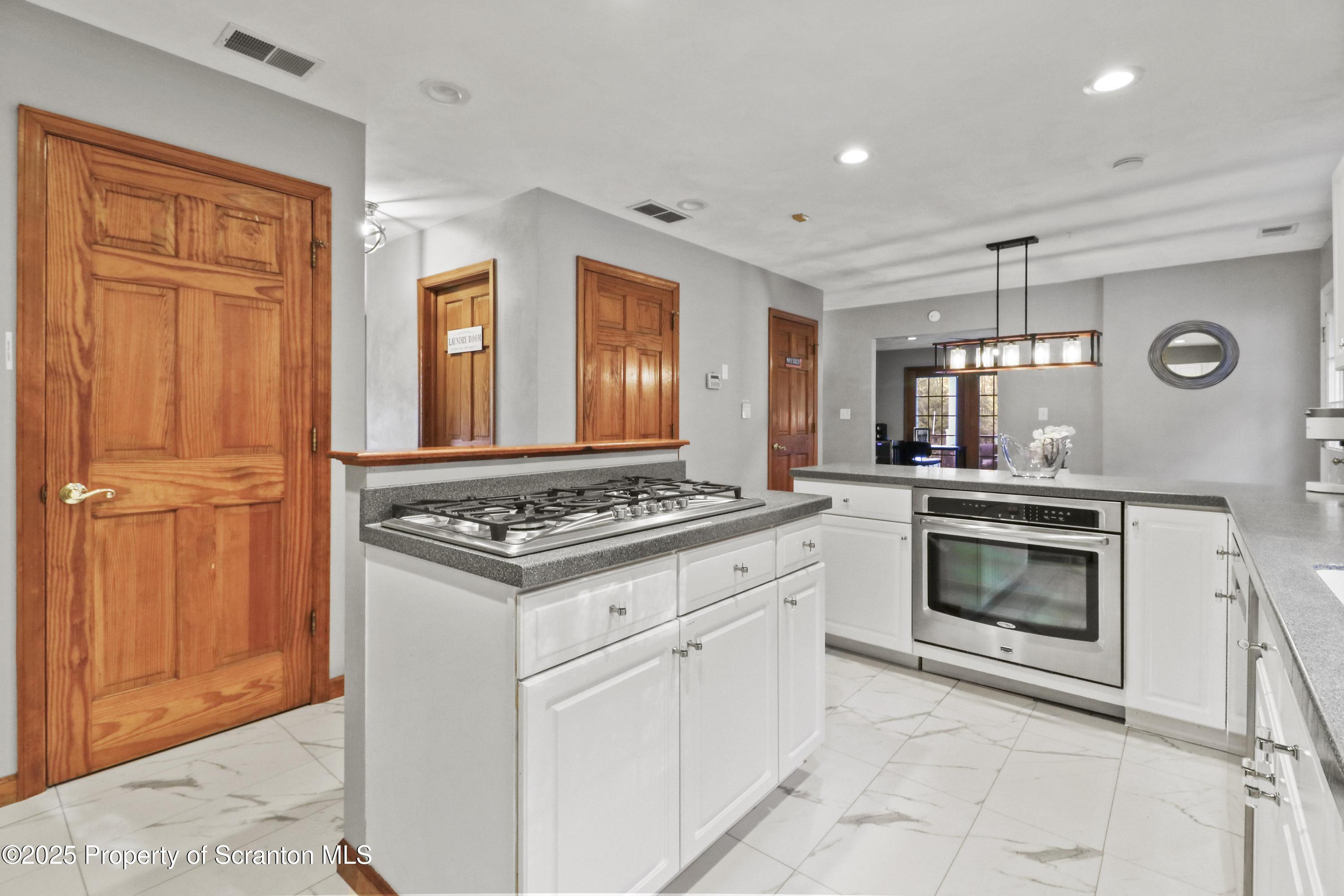 1509 Creek Road New Milford, PA 18834 - Photo 10 of 64 a kitchen with white cabinets and appliances