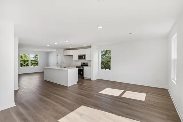 a view of kitchen with granite countertop cabinets and wooden floor