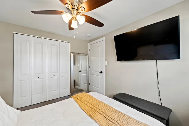 a bedroom with a bed and a flat screen tv