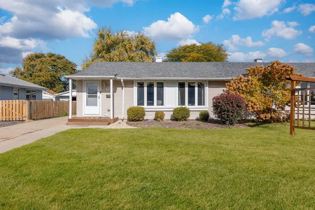a front view of a house with a garden