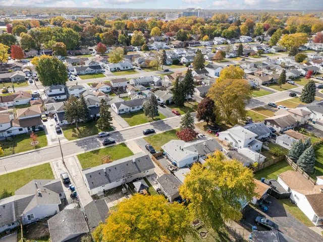 an aerial view of residential houses with outdoor space
