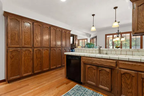 a kitchen with granite countertop wooden cabinets and white appliances
