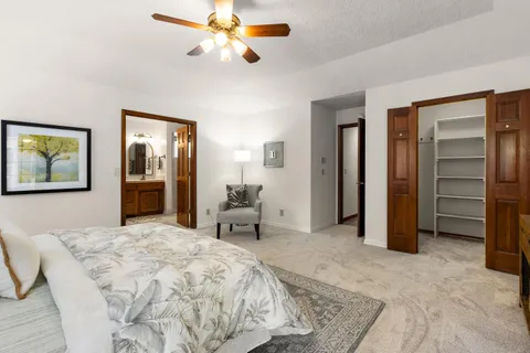 a bedroom with a bed and a chandelier