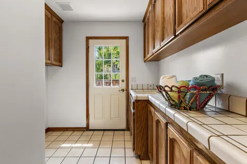 a kitchen with a stove a sink and a cabinets