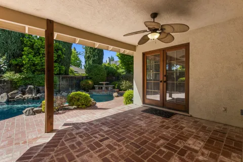 a view of a porch with furniture and garden