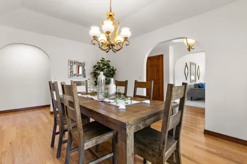 a view of a dining room with furniture wooden floor and chandelier